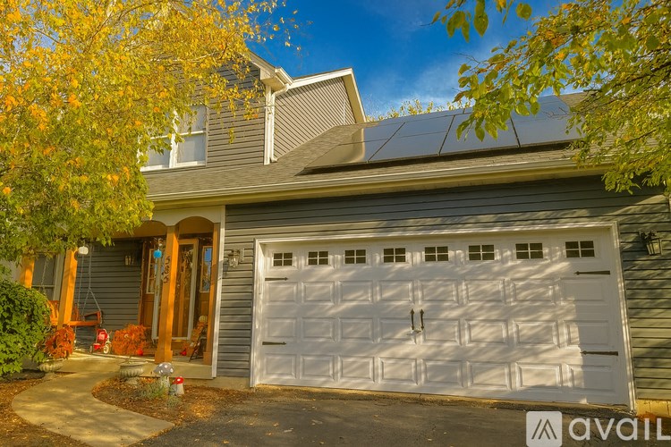 A house with a white garage door is for sale.