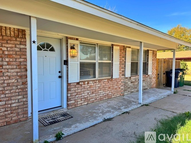 A house with a white door and a window with a light on it.