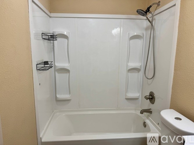 A white bathroom with a walk in shower and toilet.