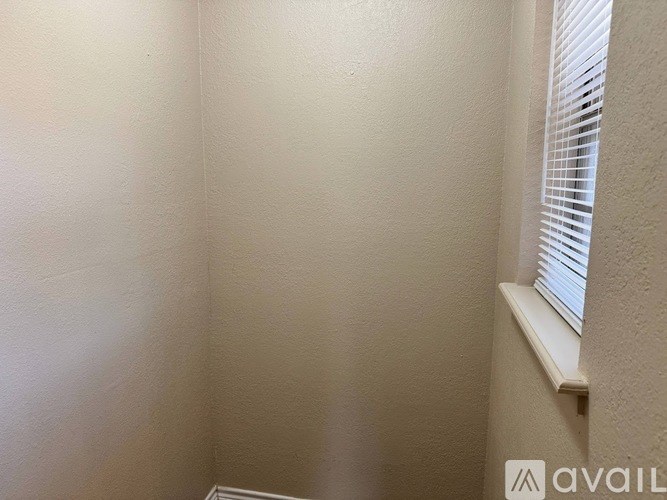 A corner of a room with a window and a wall.