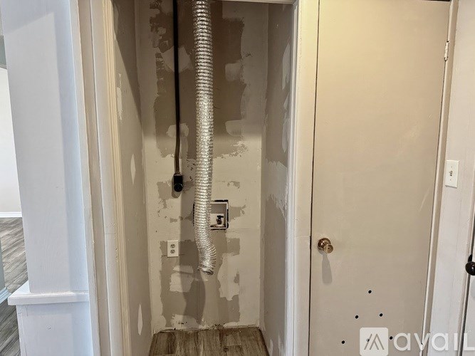 A bathroom with a shower and a door.
