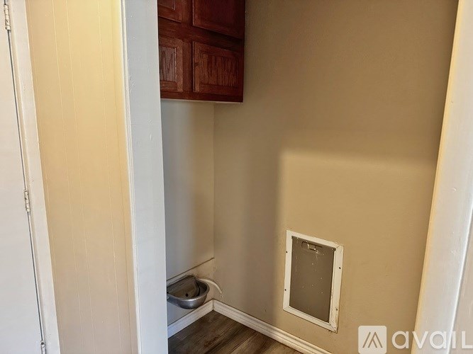 A small bathroom with a toilet and a window.