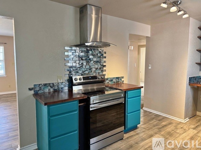 A kitchen with a stove and a blue drawer.