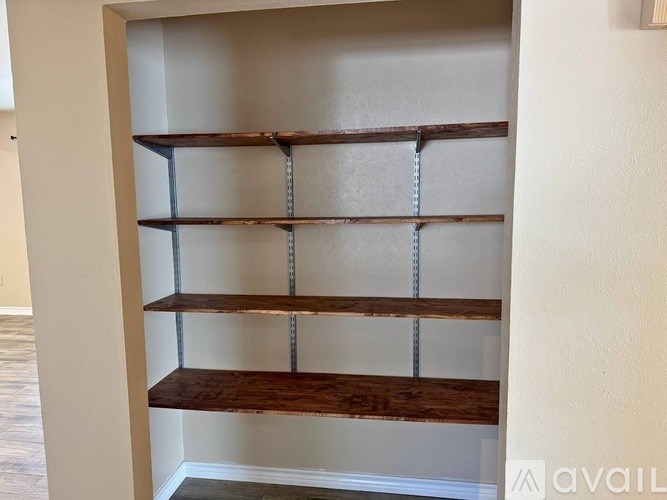 A wooden shelf with four shelves is available for use.