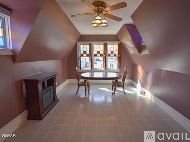 A living room with a ceiling fan and a television.