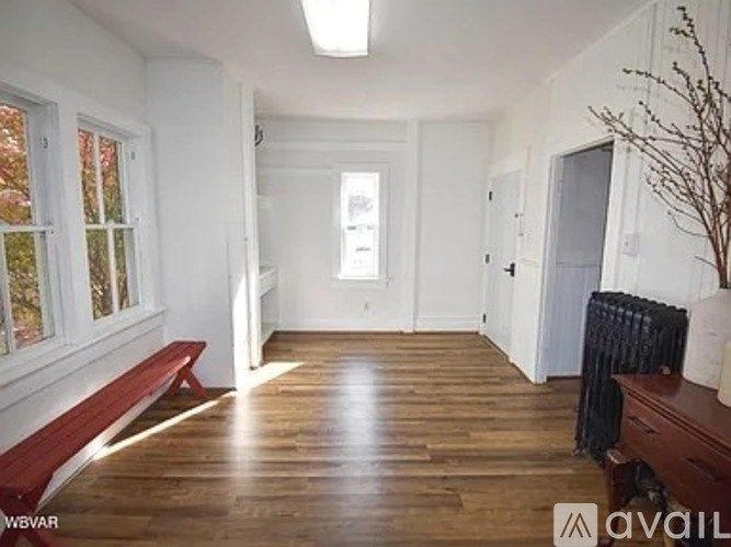 A room with wooden floors and white walls.