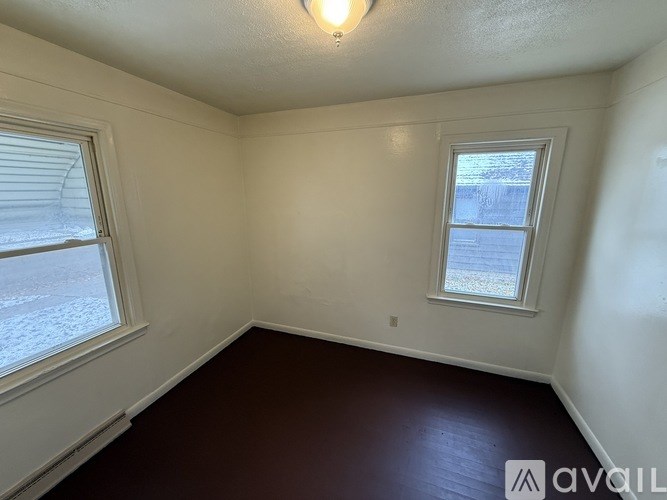 A room with a window and a smaller window on the wall.