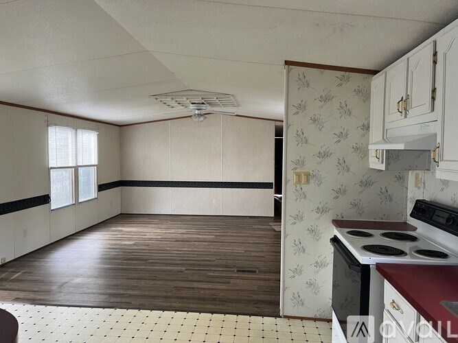 A kitchen with a stove and a dining table.