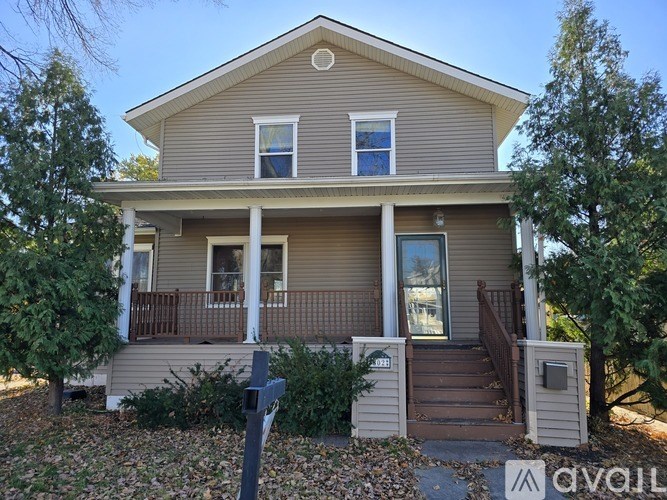 A house with a front porch and a mailbox on the right.