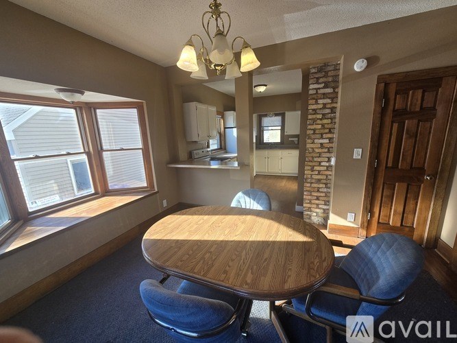 A dining room with a wooden table and blue chairs.