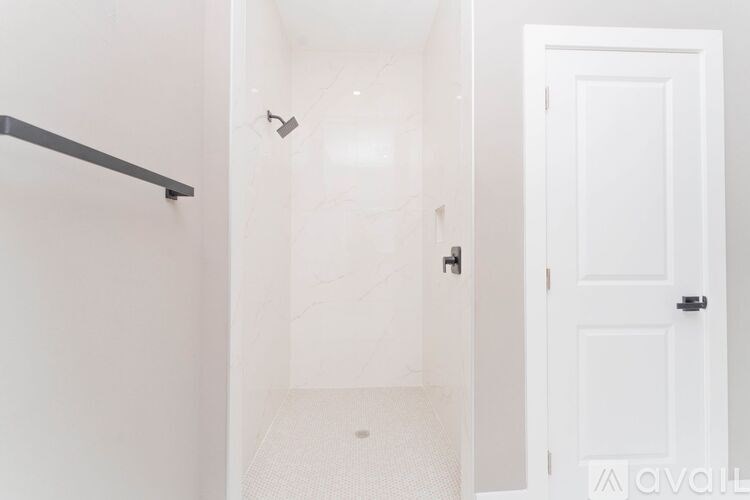 A white door is open to a hallway.