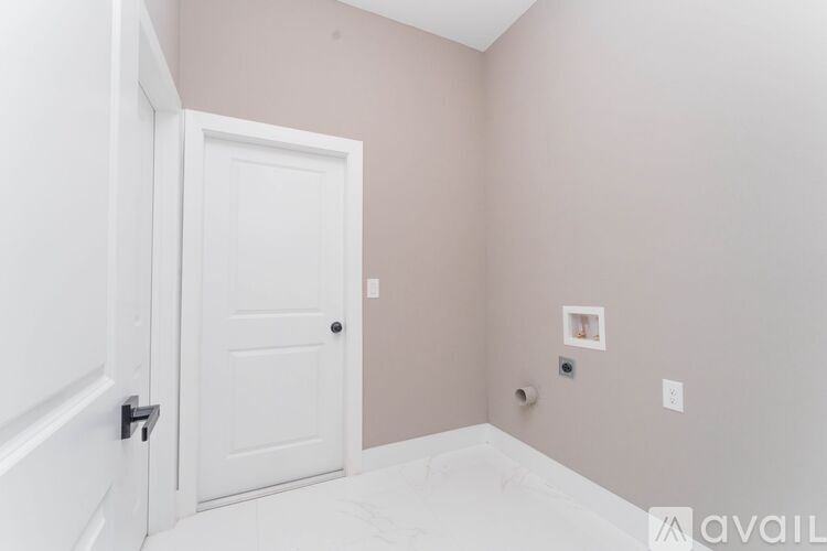 A white door with a black handle is on the left side of the image.