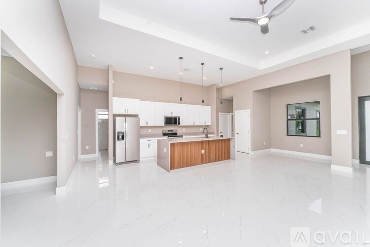 A spacious kitchen with a central island and modern appliances.