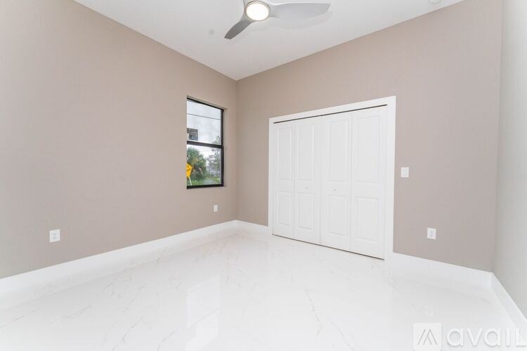 A room with a white door and a window.