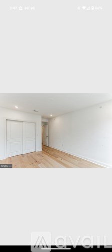 A room with white walls and wooden flooring.