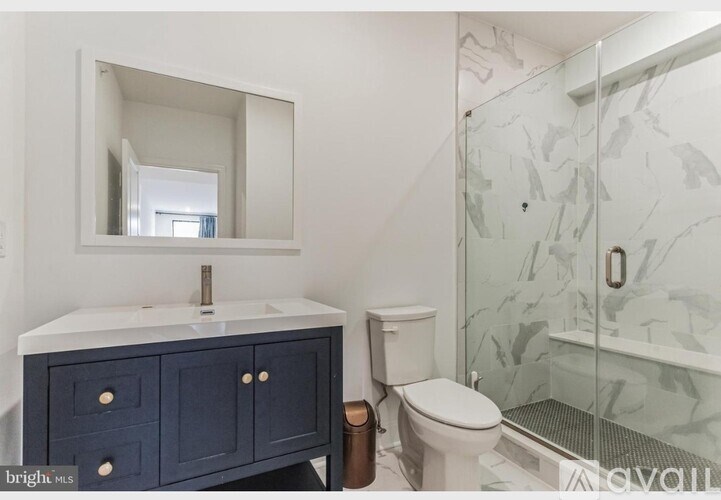 A bathroom with a white sink and a mirror above it.