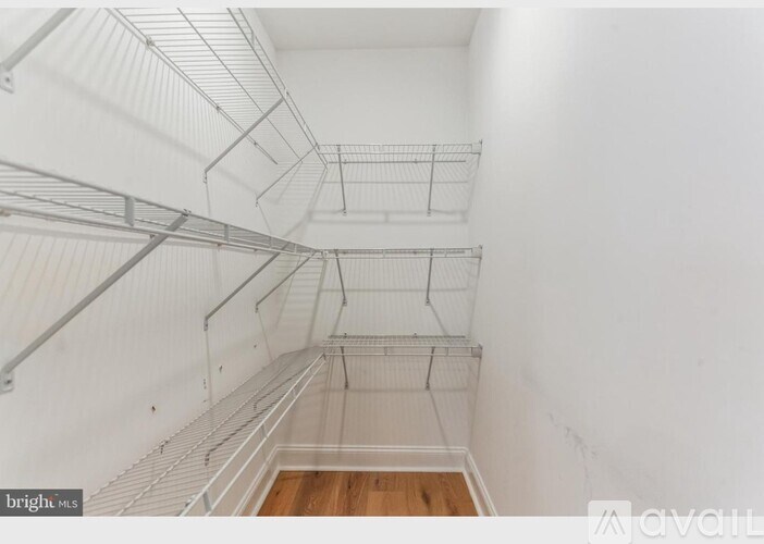 Empty white shelving in a room.