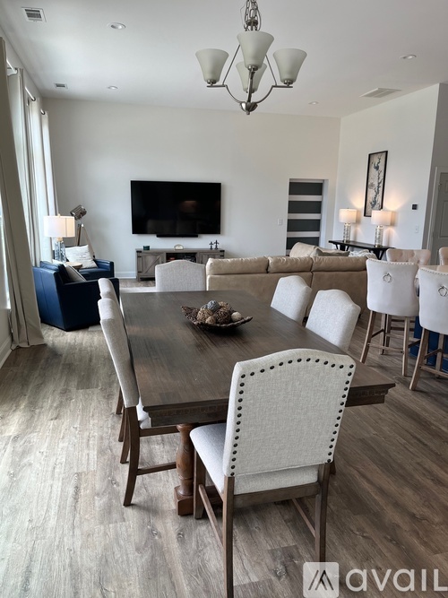A modern dining room with a large table and chairs.