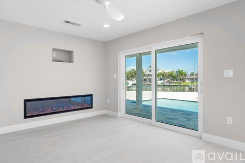 A modern living room with a fireplace and sliding glass doors.