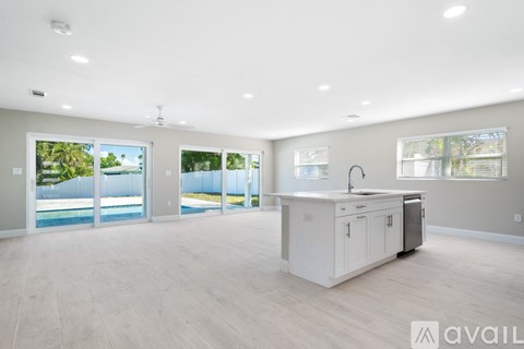 A spacious kitchen with a white cabinet and a large island in the middle of the room.