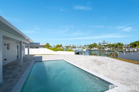 A swimming pool in a sunny backyard.