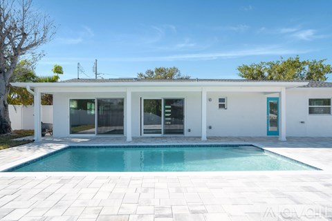 A modern house with a pool in the backyard.