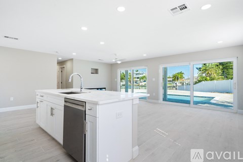 A modern kitchen with white cabinets and a large island.