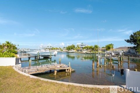 A marina with boats docked and a clear blue sky.