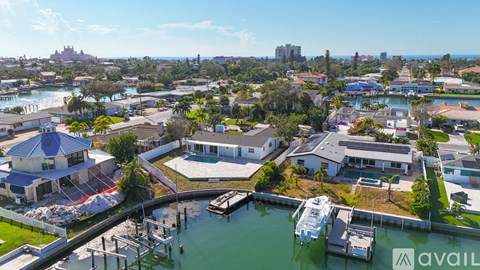 A bird's eye view of a residential area with a boat docked at a marina.