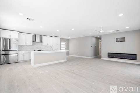 A spacious kitchen with a white countertop and stainless steel appliances.