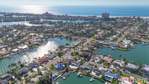 A bird's eye view of a coastal city with a river running through it.