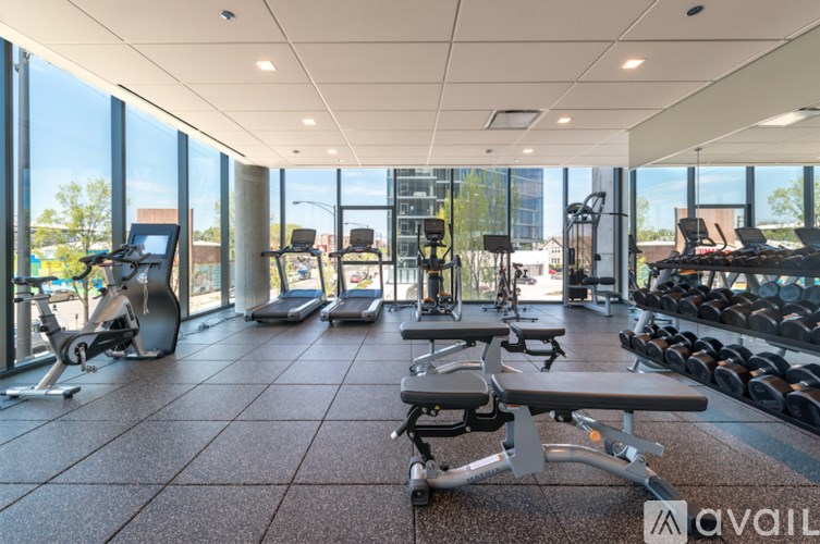 A gym with treadmills, weights, and exercise equipment.