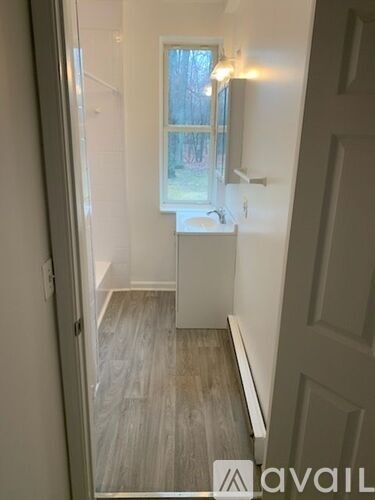 A bathroom with a sink and a window.