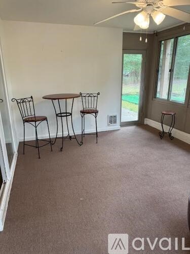 A room with a table and chairs in it.