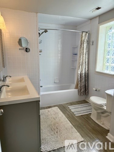 A bathroom with a sink, toilet, and bathtub.