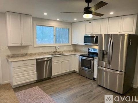 A kitchen with white cabinets and stainless steel appliances.