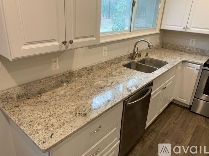 A kitchen with granite countertops and stainless steel appliances.