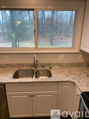 A kitchen with a sink and a window.