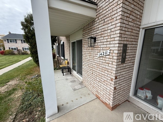 A house numbered 14211 is shown with a porch and a window.