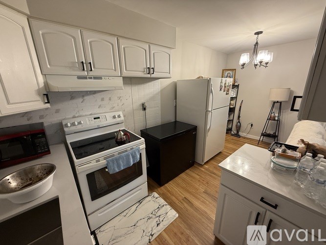 A kitchen with white cabinets and a white oven.
