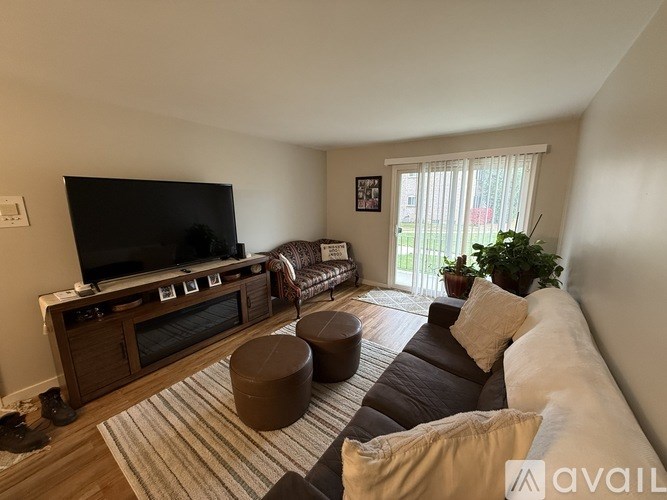 A living room with a television, a couch, and a coffee table.