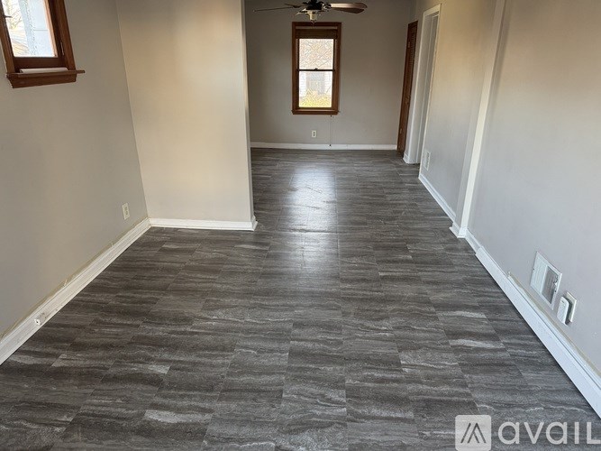 A room with a grey floor and a window.