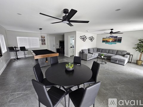 A modern living room with a black table and chairs.