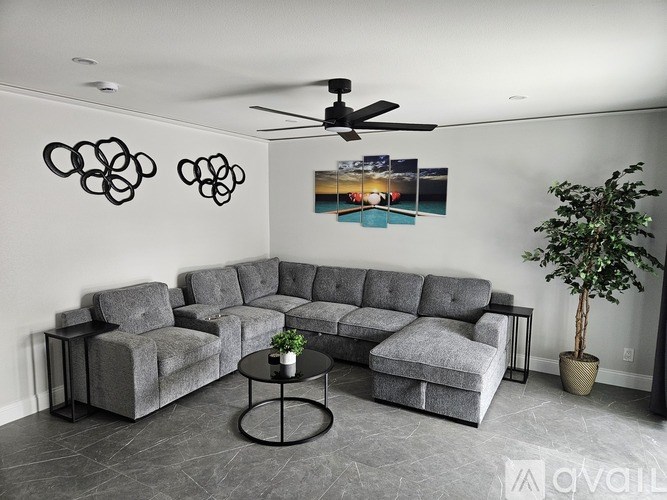 A grey sectional sofa with a coffee table in front of it.
