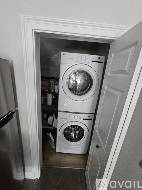 A white washing machine and dryer in a small laundry room.