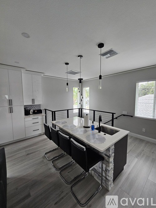 A kitchen with a large island and modern appliances.