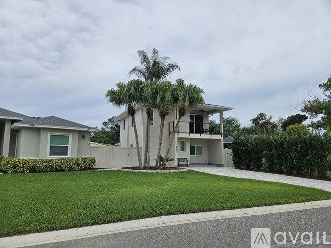 A house with a tree in front of it is for sale.