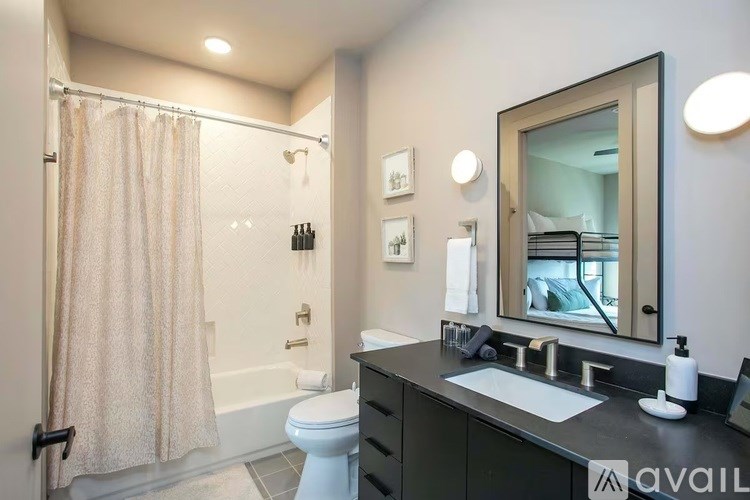 A bathroom with a toilet, sink, and shower.