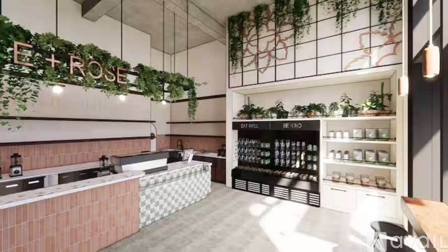 A modern cafe interior with a counter and shelves stocked with jars and bottles.