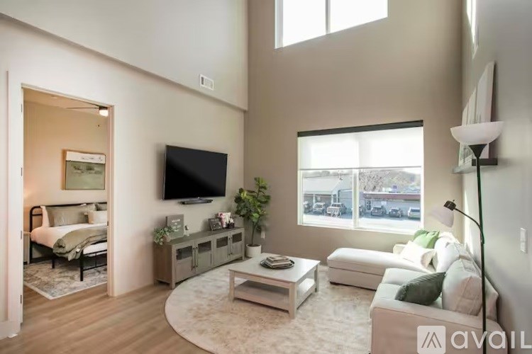 A living room with a television, a couch, and a coffee table.